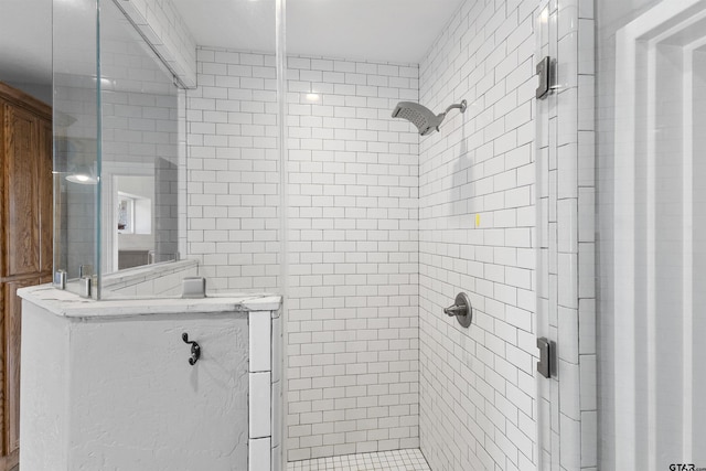 bathroom with tiled shower