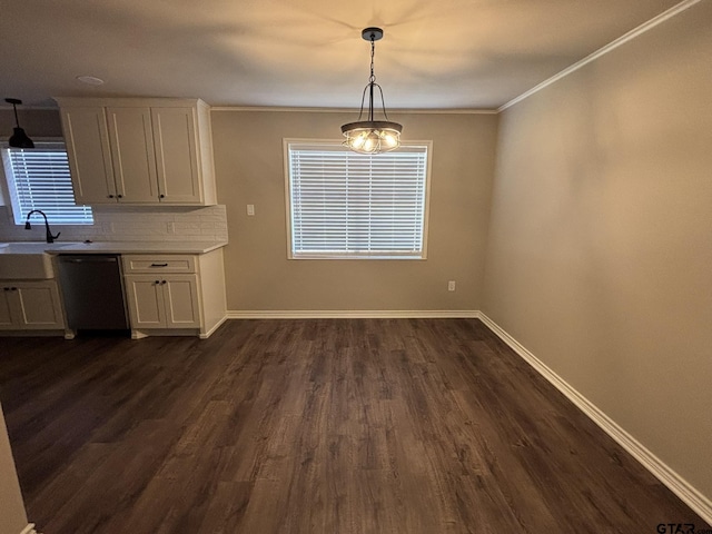 unfurnished dining area with ornamental molding, sink, and dark hardwood / wood-style floors