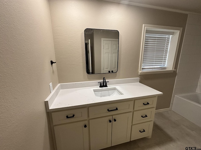 bathroom with vanity and a washtub