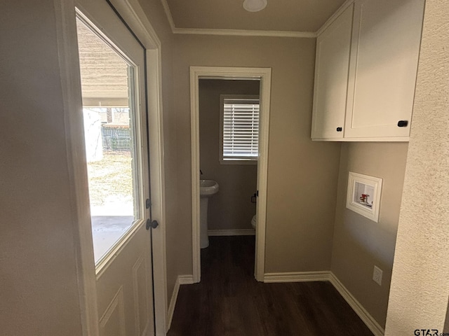 laundry area featuring dark wood-type flooring, cabinets, washer hookup, and a wealth of natural light