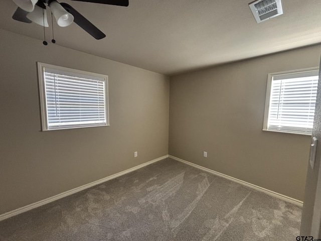 carpeted spare room with ceiling fan