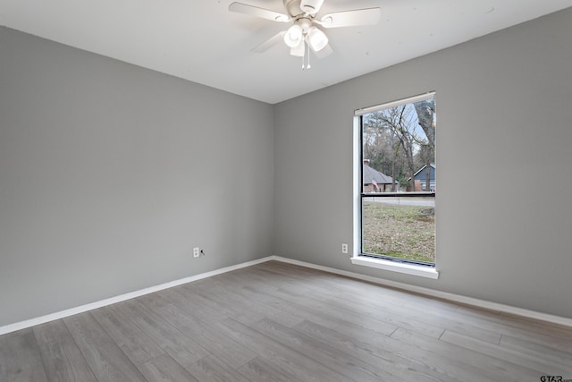 unfurnished room with ceiling fan and light hardwood / wood-style flooring