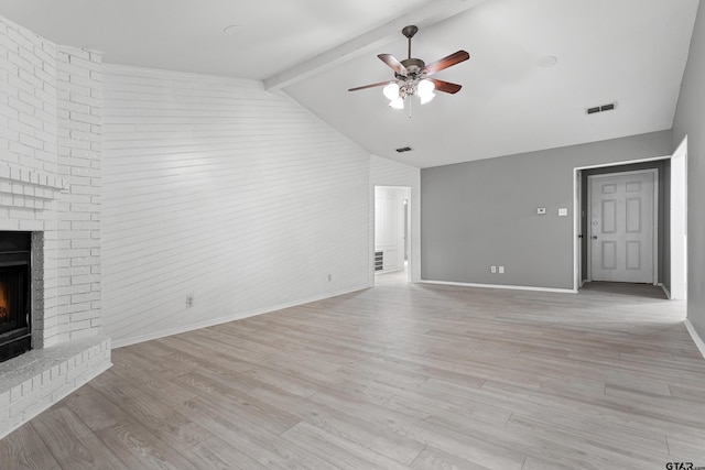 unfurnished living room with a fireplace, light hardwood / wood-style flooring, beam ceiling, ceiling fan, and high vaulted ceiling