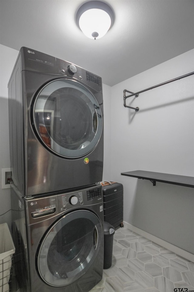 5734 Mustang Trl, Tyler, TX 75707 - laundry room featuring stacked washer and clothes dryer and baseboards