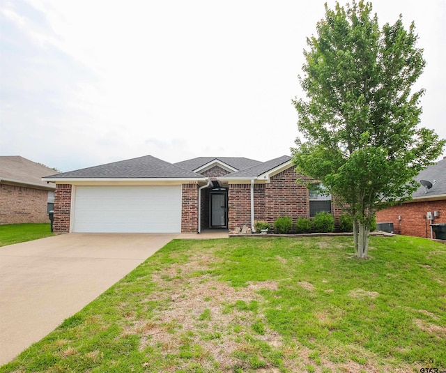 5734 Mustang Trl, Tyler, TX 75707 - ranch-style home featuring concrete driveway, an attached garage, a front yard, and brick siding