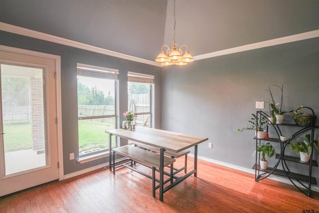 5734 Mustang Trl, Tyler, TX 75707 - dining room with a chandelier, ornamental molding, wood finished floors, baseboards, and healthy amount of natural light