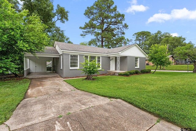 708 E Barbara St, Tyler, TX 75701 - single story home featuring concrete driveway, a front yard, an attached carport, and brick siding