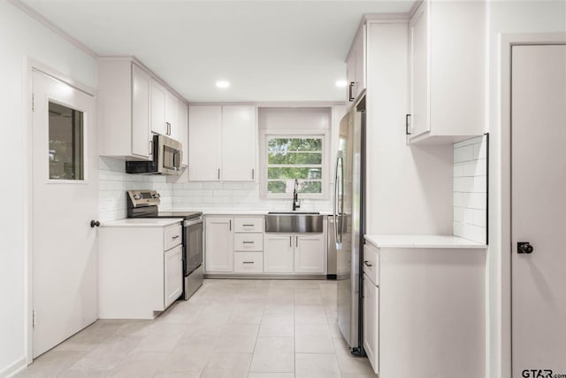 708 E Barbara St, Tyler, TX 75701 - kitchen with stainless steel appliances, decorative backsplash, light countertops, light tile patterned floors, and recessed lighting