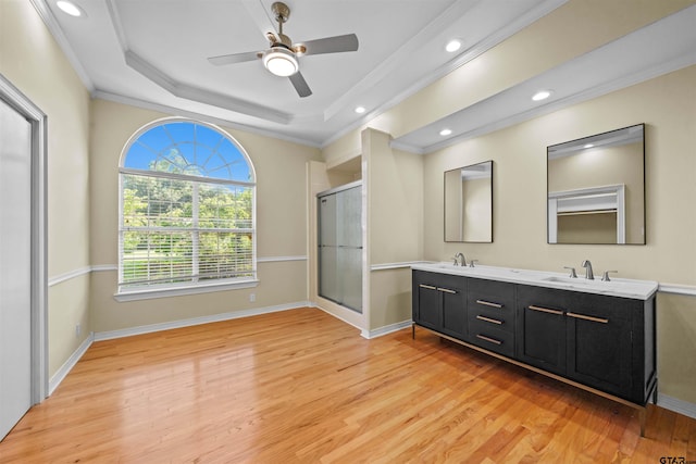 bathroom with crown molding, walk in shower, vanity, hardwood / wood-style flooring, and ceiling fan