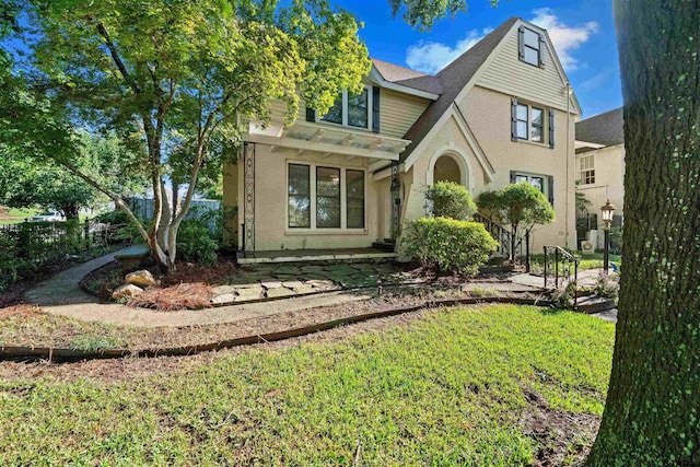 145 Rowland Pl, Tyler, TX 75701 - rear view of house with brick siding and a yard