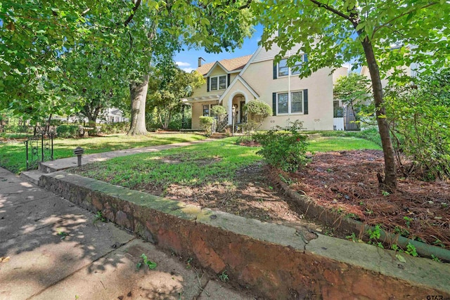 tudor home with a front yard