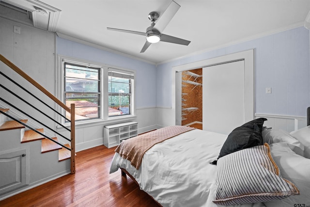 bedroom with crown molding, radiator heating unit, hardwood / wood-style flooring, and ceiling fan