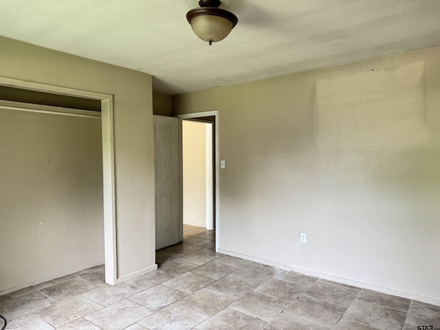 330 Randolph St, Lone Star, TX 75668 - unfurnished bedroom with a closet and light stone finish flooring