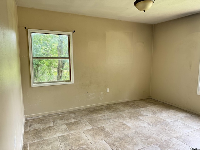 330 Randolph St, Lone Star, TX 75668 - empty room featuring baseboards and light stone finish flooring