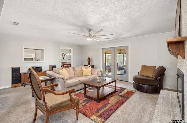 living area with light colored carpet, french doors, ornamental molding, visible vents, and a ceiling fan