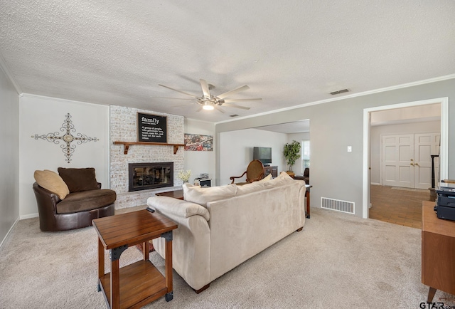 living area with a ceiling fan, crown molding, light colored carpet, and visible vents