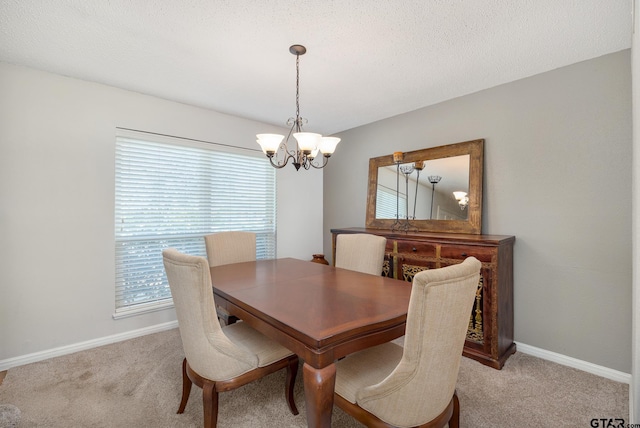 dining space with light carpet, baseboards, and a chandelier