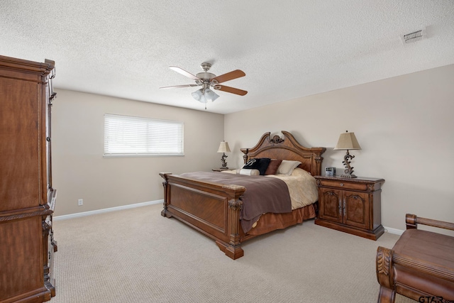 bedroom featuring baseboards, visible vents, and light carpet