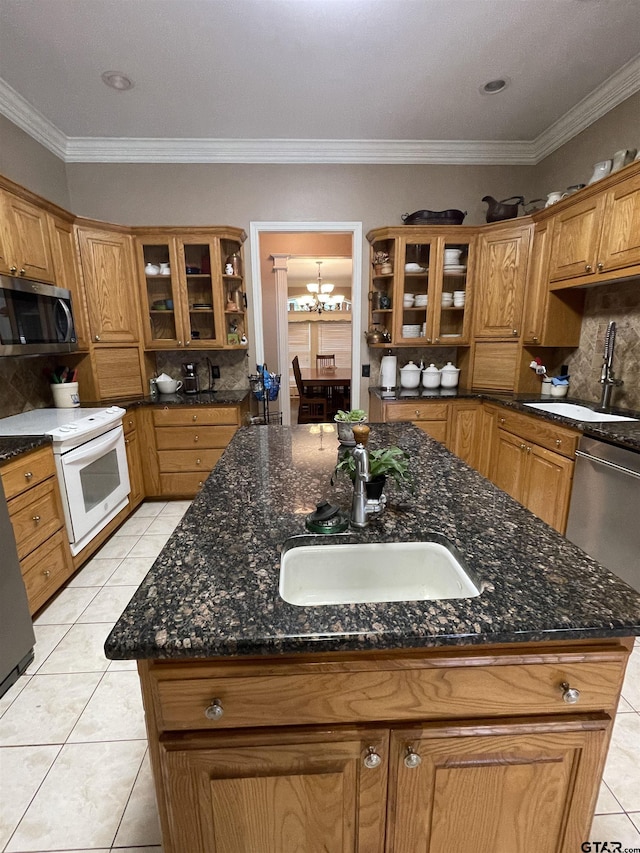 3617 Flagstone Dr, Tyler, TX 75707 - kitchen with stainless steel appliances, a sink, light tile patterned floors, backsplash, and ornamental molding