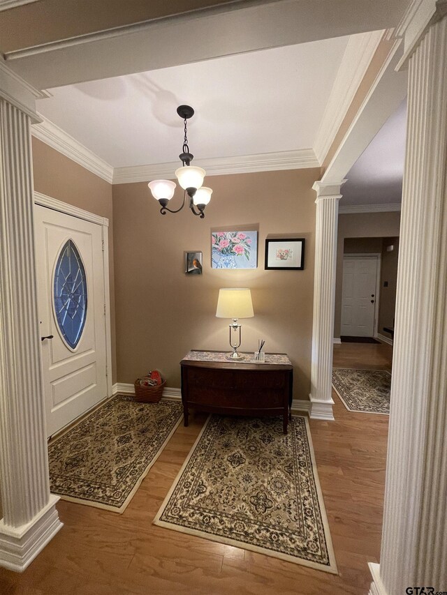 3617 Flagstone Dr, Tyler, TX 75707 - foyer entrance with decorative columns, ornamental molding, wood finished floors, baseboards, and a chandelier