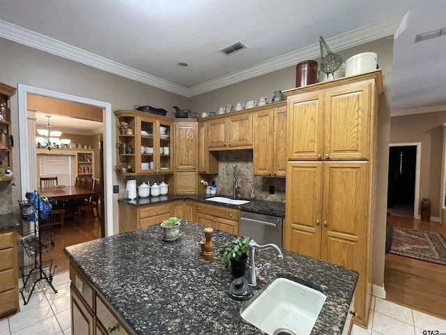 3617 Flagstone Dr, Tyler, TX 75707 - kitchen with a sink, stainless steel dishwasher, a chandelier, decorative backsplash, and crown molding