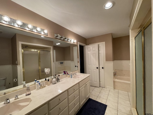 3617 Flagstone Dr, Tyler, TX 75707 - bathroom featuring a garden tub, a stall shower, double vanity, tile patterned flooring, and toilet