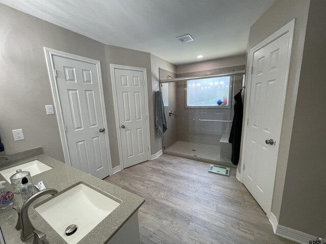 3617 Flagstone Dr, Tyler, TX 75707 - full bathroom with a shower stall, vanity, wood finished floors, and baseboards