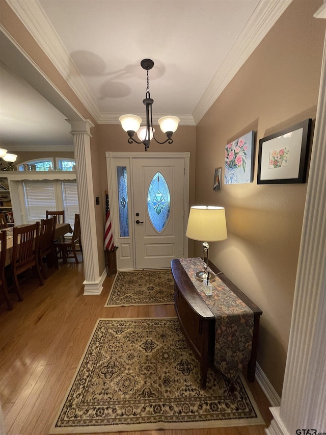 3617 Flagstone Dr, Tyler, TX 75707 - foyer with a chandelier, decorative columns, wood finished floors, ornamental molding, and baseboards