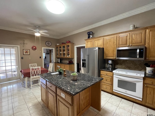 3617 Flagstone Dr, Tyler, TX 75707 - kitchen with appliances with stainless steel finishes, light tile patterned flooring, tasteful backsplash, ceiling fan, and brown cabinets