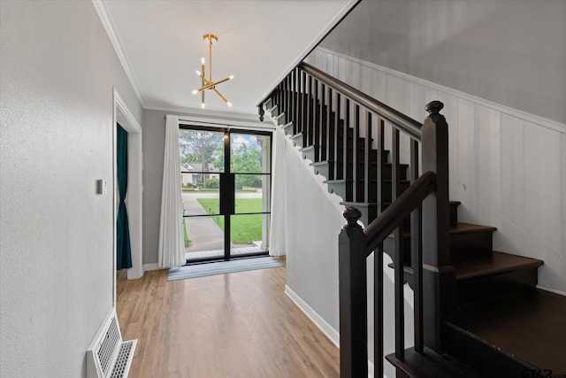 513 E Young, Longview, TX 75602 - staircase featuring a chandelier, wood finished floors, and crown molding