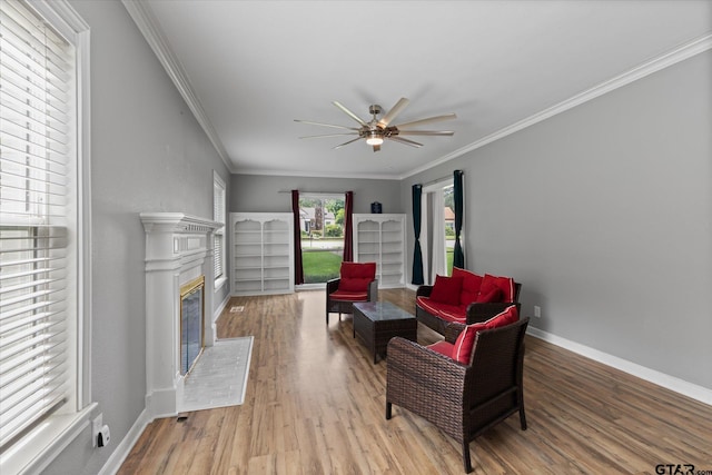 513 E Young, Longview, TX 75602 - sitting room featuring ceiling fan, wood finished floors, a glass covered fireplace, and ornamental molding