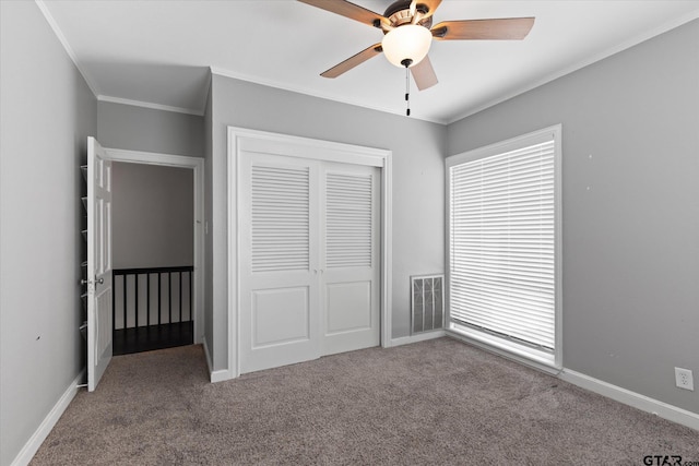 513 E Young, Longview, TX 75602 - unfurnished bedroom featuring carpet, ornamental molding, a closet, and a ceiling fan