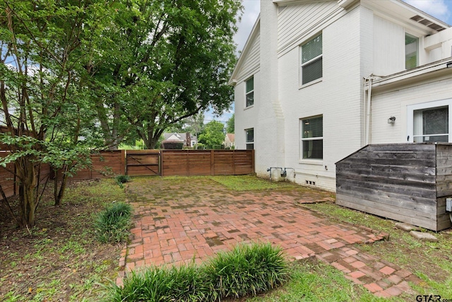 513 E Young, Longview, TX 75602 - back of house featuring a gate, a patio, and brick siding