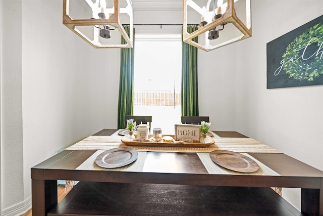 dining area featuring breakfast area and a notable chandelier