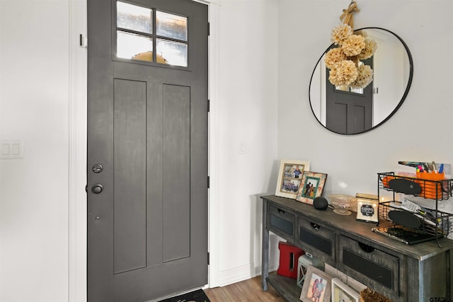 entryway featuring baseboards and wood finished floors