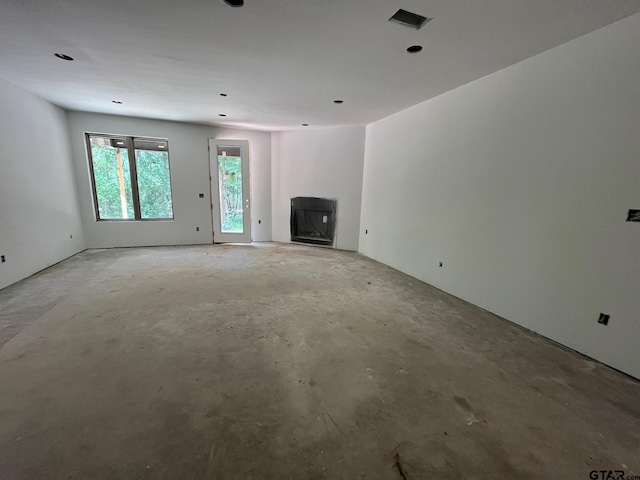 14664 Jade Forest Trl, Tyler, TX 75707 - unfurnished living room featuring concrete flooring and a fireplace