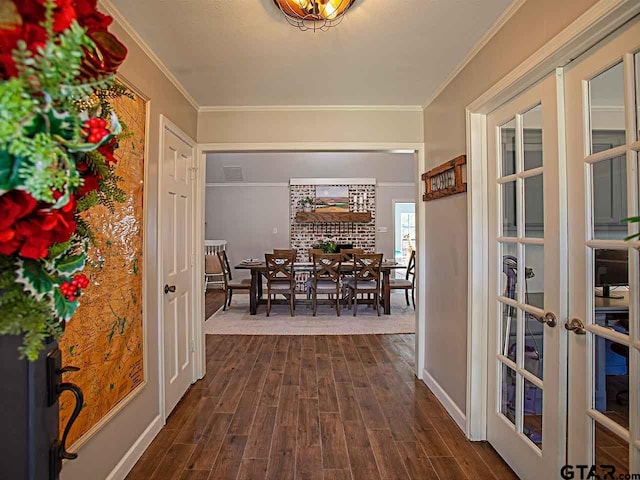 dining area with crown molding, dark hardwood / wood-style floors, and french doors