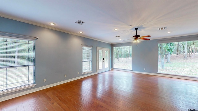 empty room featuring crown molding, french doors, ceiling fan, and light wood-type flooring