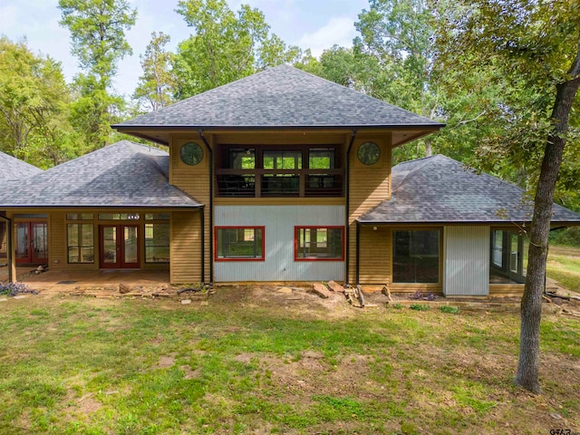 rear view of house featuring french doors and a yard