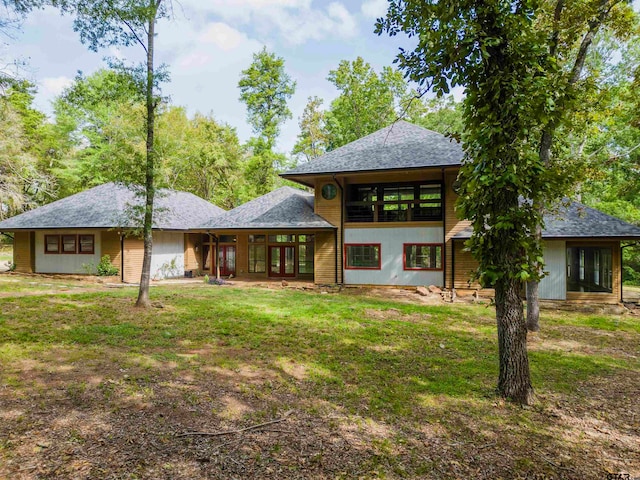 rear view of property featuring a yard and french doors