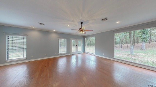 unfurnished room with ceiling fan, ornamental molding, light hardwood / wood-style flooring, and french doors