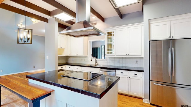 kitchen with appliances with stainless steel finishes, beamed ceiling, decorative light fixtures, white cabinetry, and extractor fan