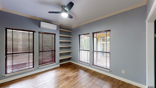 unfurnished room featuring a wall unit AC, ceiling fan, hardwood / wood-style floors, and ornamental molding