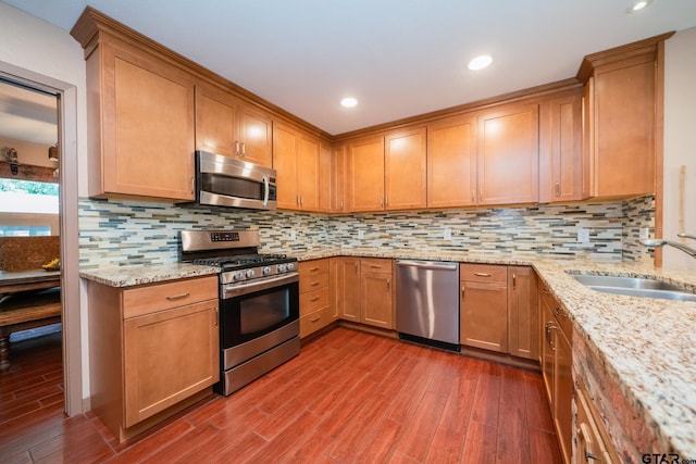 kitchen with dark hardwood / wood-style flooring, decorative backsplash, appliances with stainless steel finishes, and sink