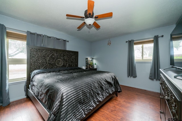 bedroom featuring a textured ceiling, dark hardwood / wood-style floors, and ceiling fan