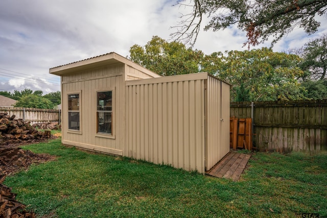 view of outbuilding featuring a lawn