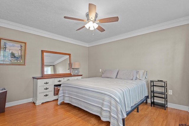 bedroom with a textured ceiling, ceiling fan, light wood-type flooring, and crown molding