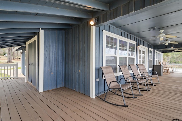 wooden deck featuring ceiling fan