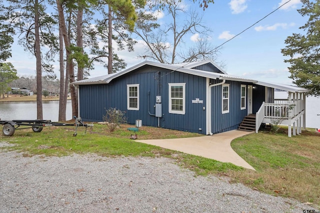 view of front of house featuring a water view and a front lawn