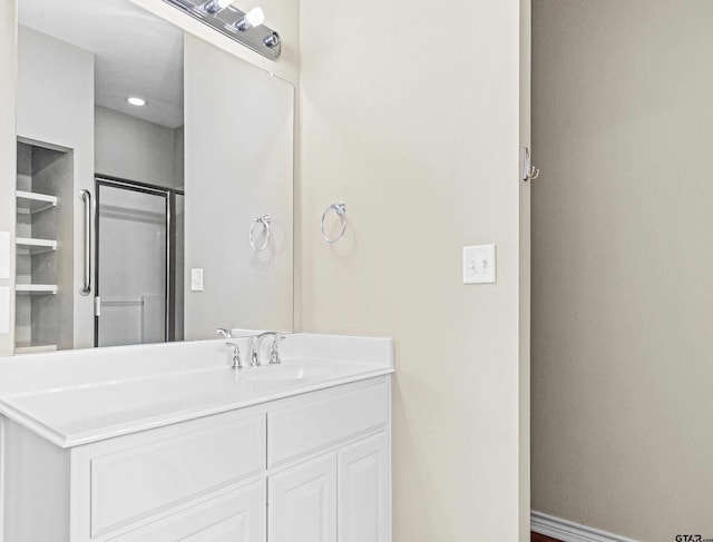 bathroom featuring an enclosed shower and vanity